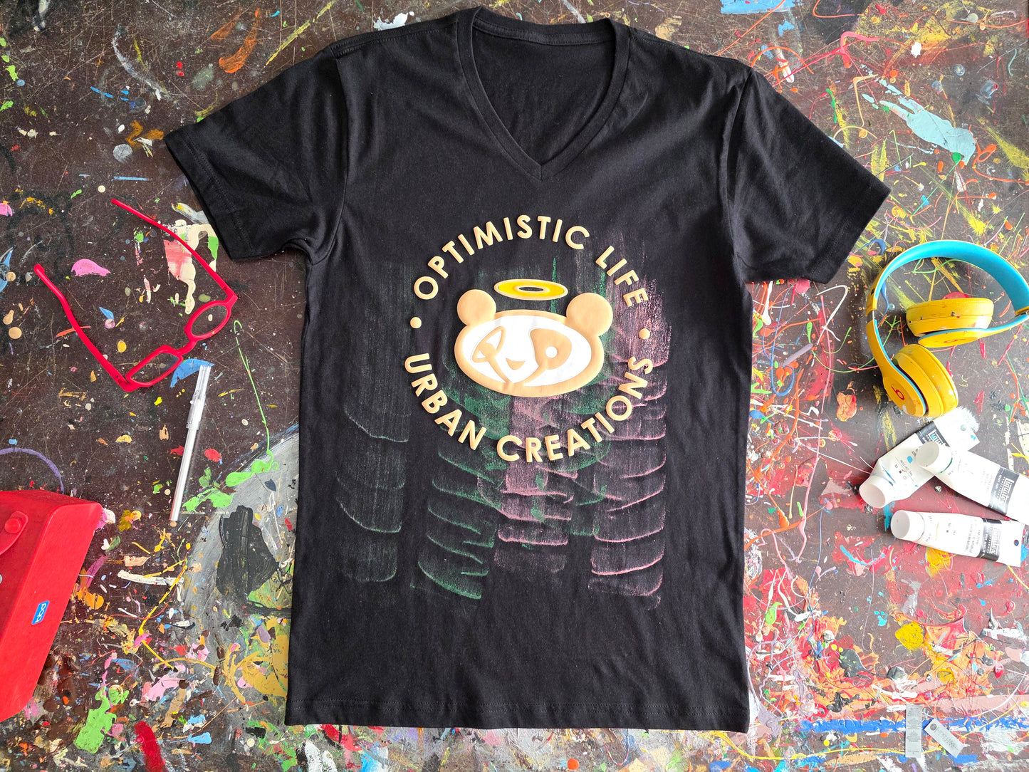 Black t-shirt with a graphic design on a colorful, textured surface