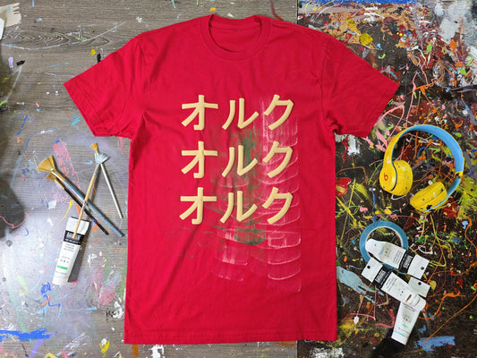 Red t-shirt with yellow text on a colorful, textured surface